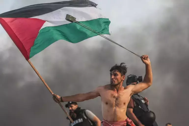 Man with Palestinian flag.png
