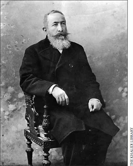Picture of older man sitting in a chair for a portrait