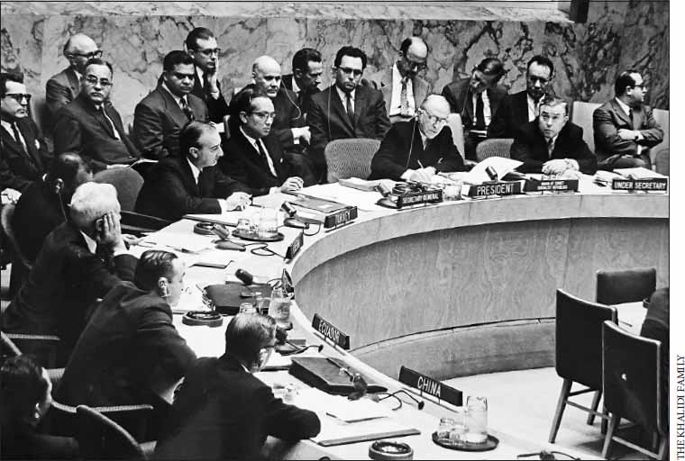 Black and white picture of people sitting behind a long desk at UN