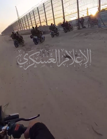 File:Palestinian resistance fighters driving through the border fence 7 oct 2023.png