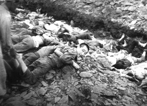 Prisoners lie on the ground before execution by South Korean troops near Daejon, South Korea, July 1950. Photo by U.S. Army Maj. Abbott.jpg