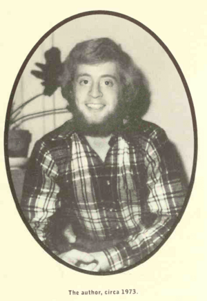 Photograph of the author sitting for a picture looking at camera